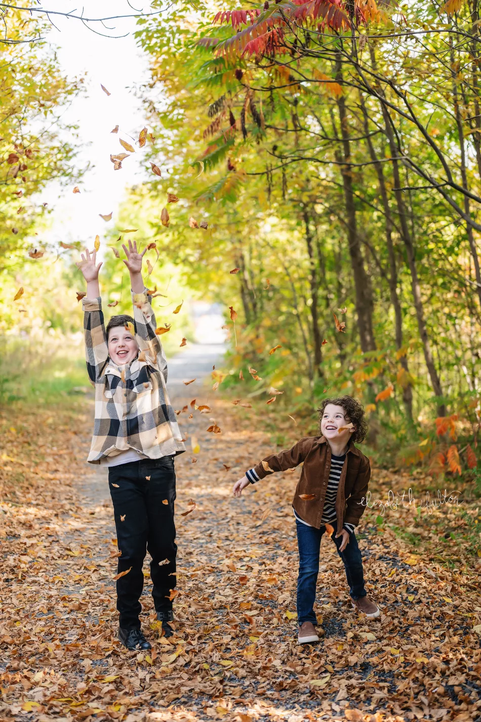 fall mini session kids throwing leaves photo